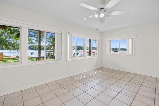 5110 W Lake Shore Dr, Wonder Lake, IL 60097 - spare room with light tile patterned flooring, a water view, and a ceiling fan