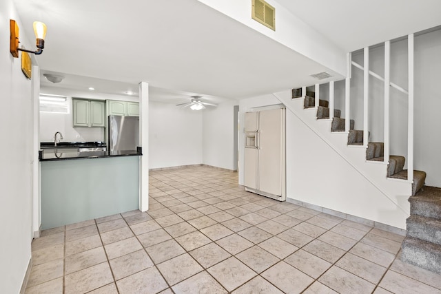 5110 W Lake Shore Dr, Wonder Lake, IL 60097 - kitchen with white fridge with ice dispenser, freestanding refrigerator, dark countertops, a ceiling fan, and recessed lighting