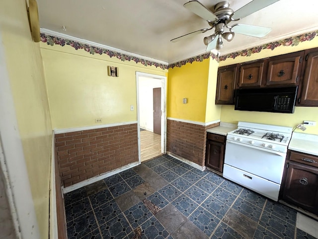 451 Tahoe St, Park Forest, IL 60466 - kitchen with black microwave, white gas range, wainscoting, dark brown cabinets, and a ceiling fan
