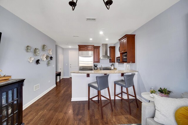 50 N Plum Grove Rd Unit 502E, Palatine, IL 60067 - kitchen with wall chimney exhaust hood, appliances with stainless steel finishes, a peninsula, dark wood finished floors, and a kitchen bar