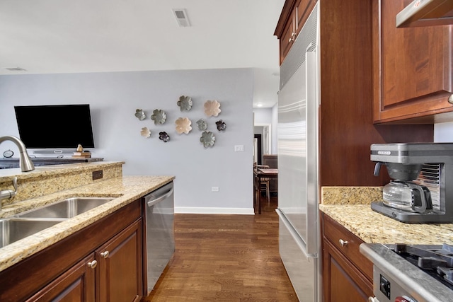 50 N Plum Grove Rd Unit 502E, Palatine, IL 60067 - kitchen featuring a sink, appliances with stainless steel finishes, dark wood finished floors, baseboards, and light stone countertops