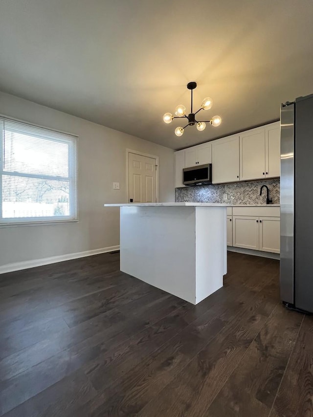 3403 Susan Ln, Steger, IL 60475 - kitchen featuring stainless steel appliances, dark wood-style floors, a chandelier, white cabinetry, and light countertops