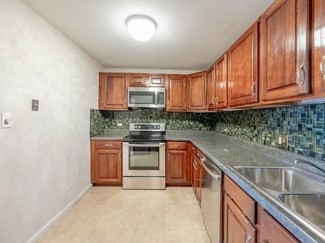 1415 N Dearborn St Unit 25D, Chicago, IL 60610 - kitchen featuring appliances with stainless steel finishes, a sink, brown cabinets, and tasteful backsplash