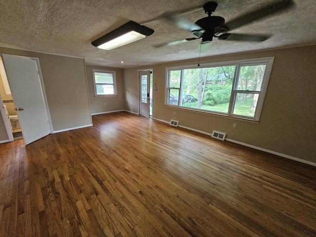 1311 N Neil St, Champaign, IL 61820 - spare room featuring dark wood-type flooring, ceiling fan, a textured ceiling, and baseboards
