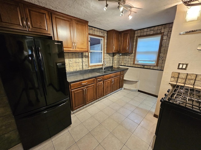 1311 N Neil St, Champaign, IL 61820 - kitchen with freestanding refrigerator, a sink, gas stove, ceiling fan, and dark countertops