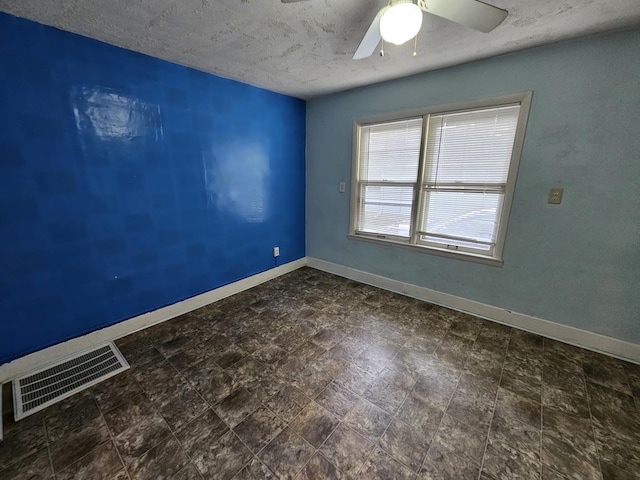 1311 N Neil St, Champaign, IL 61820 - spare room featuring ceiling fan, baseboards, and a textured ceiling