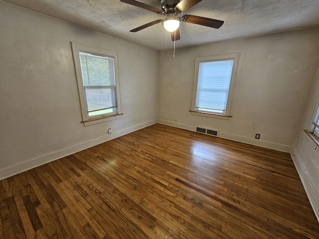 1311 N Neil St, Champaign, IL 61820 - spare room featuring wood finished floors, a ceiling fan, and baseboards