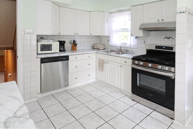 1N485 Neltnor Blvd, West Chicago, IL 60185 - kitchen featuring appliances with stainless steel finishes, under cabinet range hood, tasteful backsplash, and white cabinetry