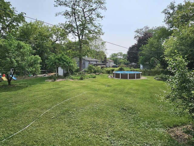 1N485 Neltnor Blvd, West Chicago, IL 60185 - view of green lawn featuring an outdoor pool