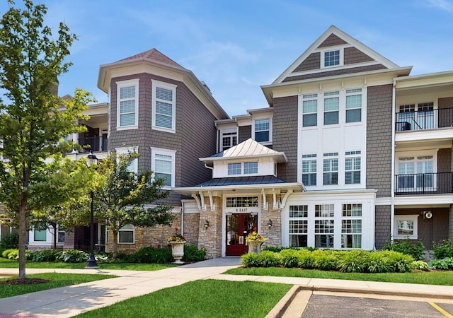 8 E Kennedy Ln Unit 302, Hinsdale, IL 60521 - view of front of property with a standing seam roof, stone siding, and a metal roof