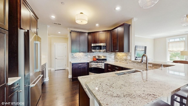 8 E Kennedy Ln Unit 302, Hinsdale, IL 60521 - kitchen with appliances with stainless steel finishes, ornamental molding, light stone counters, a peninsula, and decorative backsplash