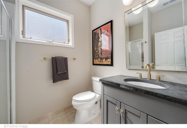912 W Barry Ave Unit 3, Chicago, IL 60657 - bathroom featuring toilet, vanity, tile patterned flooring, baseboards, and a shower with shower door
