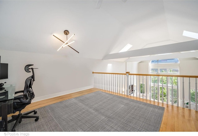 912 W Barry Ave Unit 3, Chicago, IL 60657 - unfurnished office featuring wood finished floors, a skylight, vaulted ceiling, and baseboards