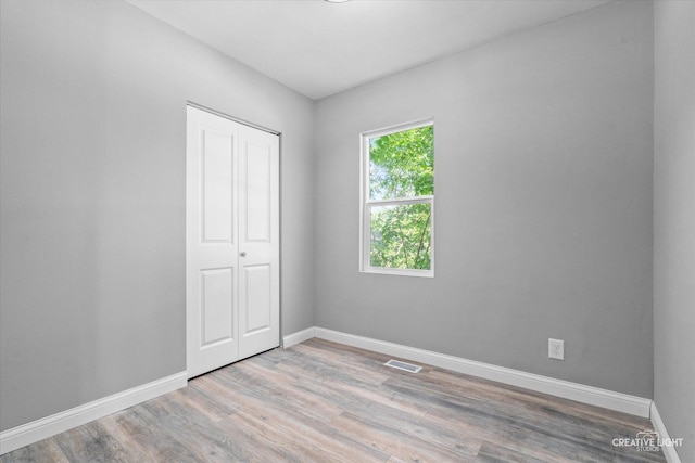 455 N River St, Montgomery, IL 60538 - unfurnished bedroom with wood finished floors and a closet
