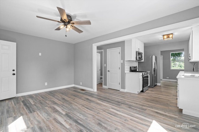 455 N River St, Montgomery, IL 60538 - unfurnished living room with a ceiling fan and wood finished floors