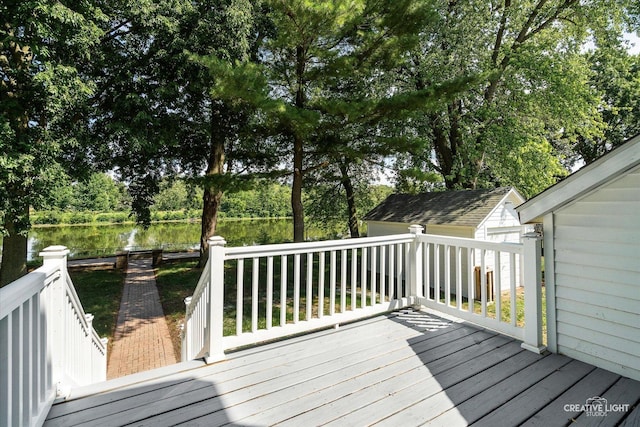 455 N River St, Montgomery, IL 60538 - wooden deck featuring a water view, view of wooded area, and a storage shed