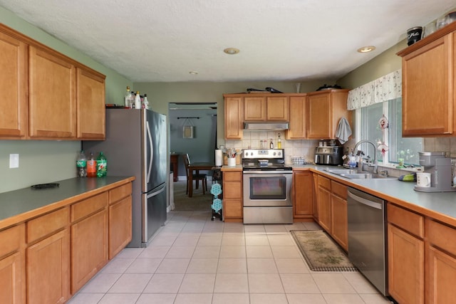 4649 Circle Dr, Heyworth, IL 61745 - kitchen with stainless steel appliances, under cabinet range hood, tasteful backsplash, light tile patterned floors, and recessed lighting