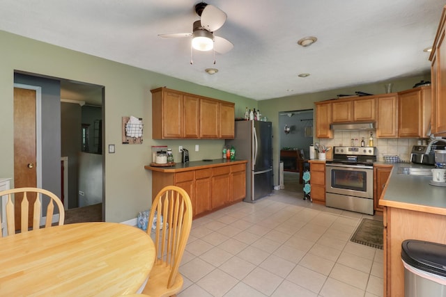 4649 Circle Dr, Heyworth, IL 61745 - kitchen with stainless steel appliances, backsplash, a ceiling fan, light tile patterned floors, and under cabinet range hood