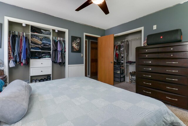 4649 Circle Dr, Heyworth, IL 61745 - carpeted bedroom featuring a wainscoted wall, multiple closets, and ceiling fan