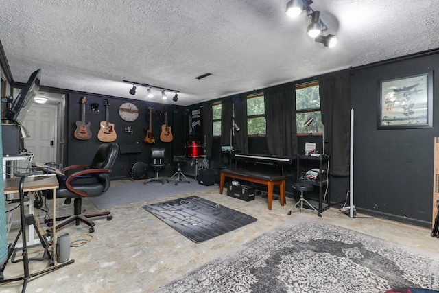 4649 Circle Dr, Heyworth, IL 61745 - playroom featuring a textured ceiling and unfinished concrete floors