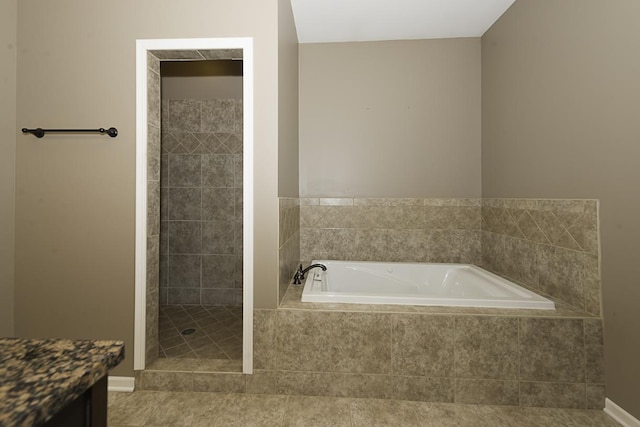 149 W Prairiefield Ave, Cortland, IL 60112 - full bathroom featuring a bath, a tile shower, vanity, and baseboards