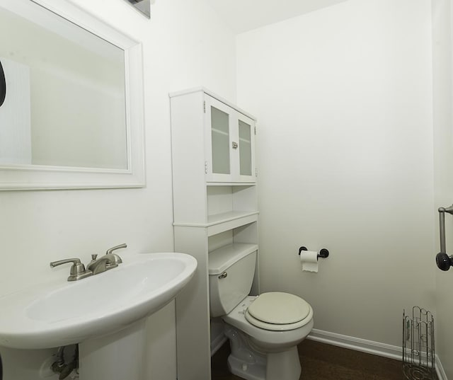 149 W Prairiefield Ave, Cortland, IL 60112 - half bathroom with toilet, baseboards, a sink, and wood finished floors