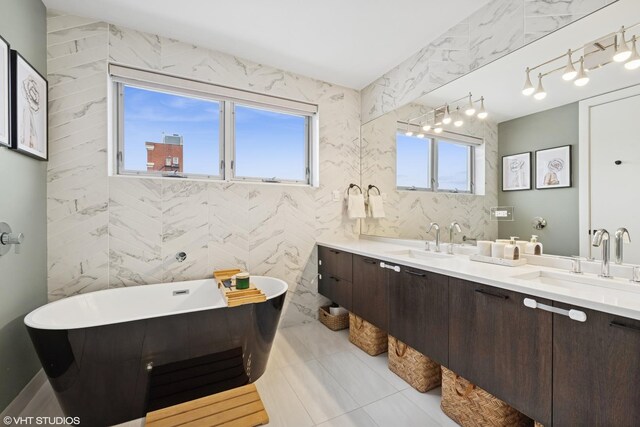 1233 N Paulina St Unit 3N, Chicago, IL 60622 - full bath with a freestanding bath, double vanity, tile walls, and tile patterned floors