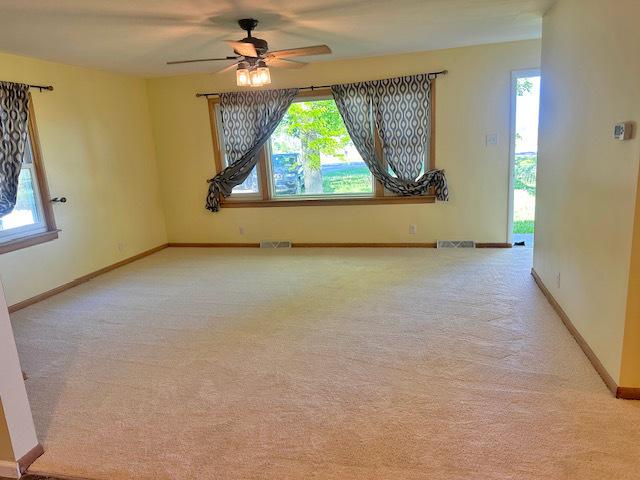 241 N Somonauk Rd, Cortland, IL 60112 - unfurnished room featuring a ceiling fan, light carpet, and baseboards