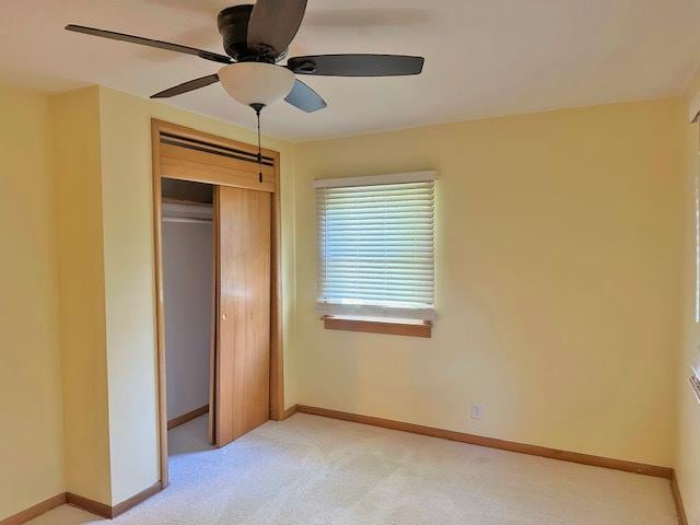 241 N Somonauk Rd, Cortland, IL 60112 - unfurnished bedroom with a closet, light colored carpet, baseboards, and ceiling fan