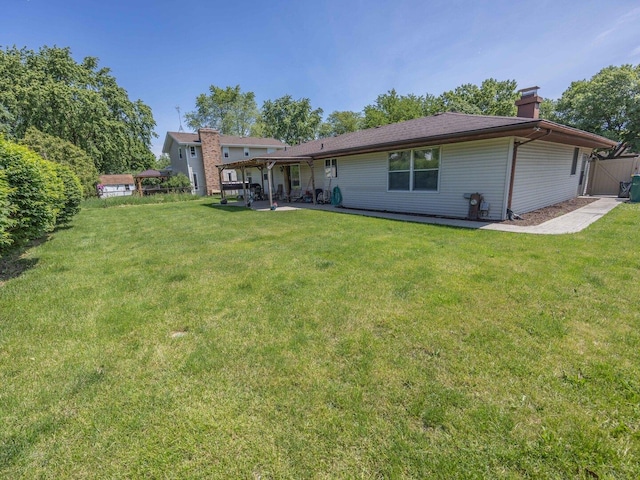 601 Fairlane Dr, Joliet, IL 60435 - rear view of house with a chimney and a patio