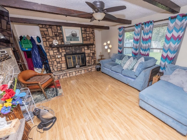 601 Fairlane Dr, Joliet, IL 60435 - living room with beamed ceiling, wood finished floors, ceiling fan, a textured ceiling, and a stone fireplace