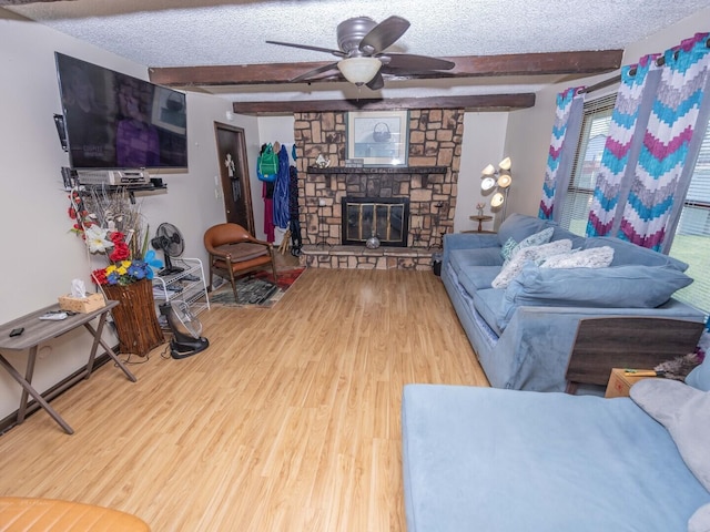 601 Fairlane Dr, Joliet, IL 60435 - living area with wood finished floors, beam ceiling, ceiling fan, a textured ceiling, and a stone fireplace