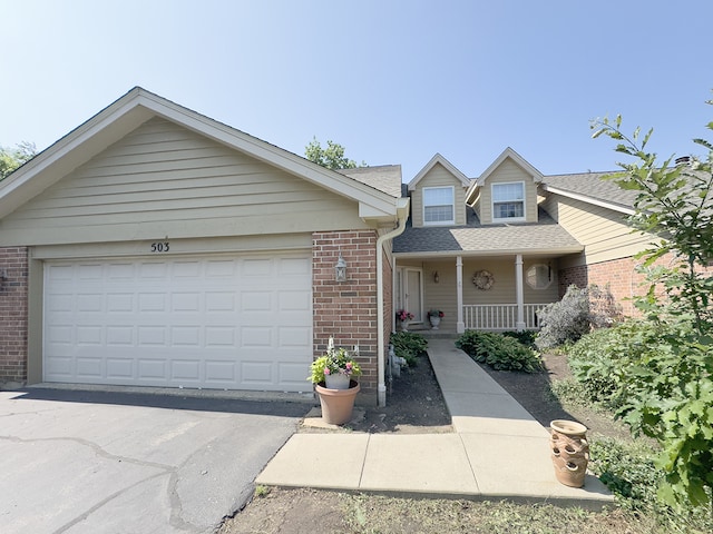 503 Shagbark Dr Unit 503, Elgin, IL 60123 - view of front of property featuring brick siding, a porch, asphalt driveway, and an attached garage
