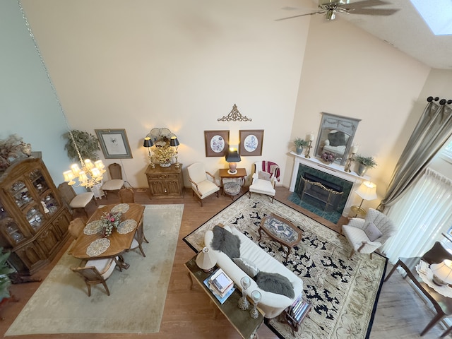 503 Shagbark Dr Unit 503, Elgin, IL 60123 - living area with high vaulted ceiling, a high end fireplace, wood finished floors, a ceiling fan, and a skylight