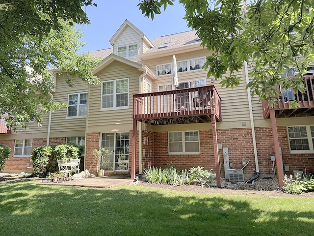 503 Shagbark Dr Unit 503, Elgin, IL 60123 - rear view of house featuring a lawn, brick siding, and a wooden deck