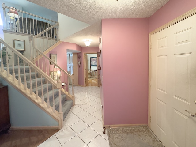503 Shagbark Dr Unit 503, Elgin, IL 60123 - stairs featuring a textured ceiling and tile patterned floors