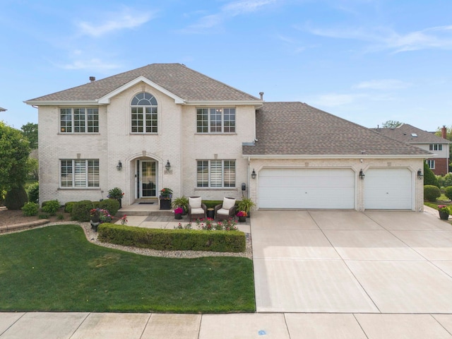 18210 W Winds Ln, Orland Park, IL 60467 - view of front facade with a garage, concrete driveway, a front yard, and a shingled roof