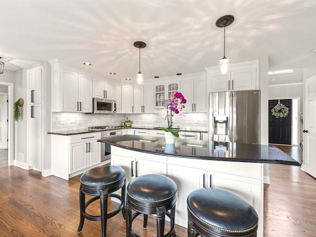 18210 W Winds Ln, Orland Park, IL 60467 - kitchen with stainless steel appliances, white cabinets, and decorative backsplash