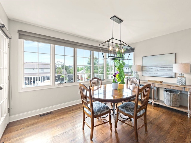 18210 W Winds Ln, Orland Park, IL 60467 - dining area with baseboards, wood finished floors, and a chandelier