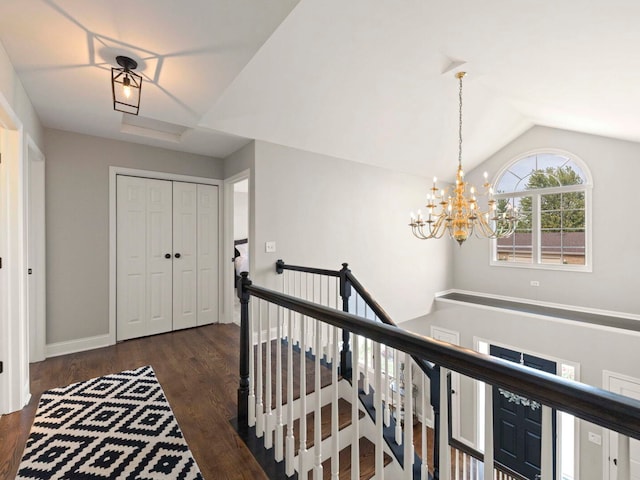 18210 W Winds Ln, Orland Park, IL 60467 - hallway with an upstairs landing, a chandelier, lofted ceiling, dark wood finished floors, and baseboards