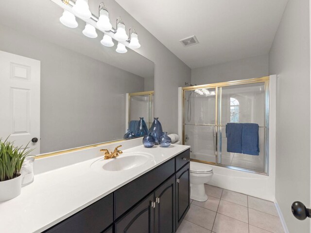 18210 W Winds Ln, Orland Park, IL 60467 - bathroom featuring toilet, vanity, tile patterned floors, bath / shower combo with glass door, and baseboards