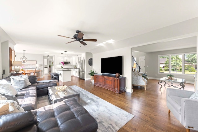 18210 W Winds Ln, Orland Park, IL 60467 - living room with ceiling fan, dark wood-style floors, stairs, and baseboards