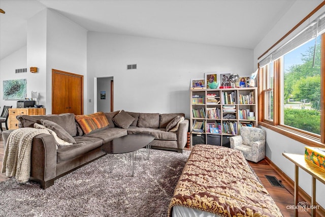 1923-25 Monday Dr, Elgin, IL 60123 - living room with wood finished floors, high vaulted ceiling, and baseboards