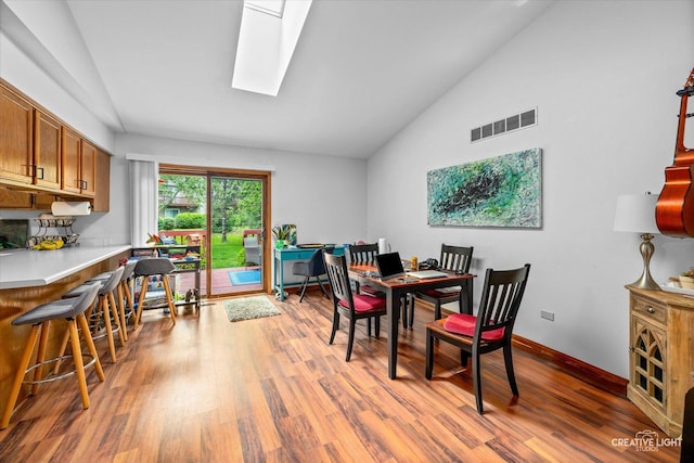 1923-25 Monday Dr, Elgin, IL 60123 - dining space with wood finished floors, baseboards, high vaulted ceiling, and a skylight