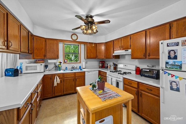 1923-25 Monday Dr, Elgin, IL 60123 - kitchen with white appliances, under cabinet range hood, a ceiling fan, brown cabinetry, and light countertops