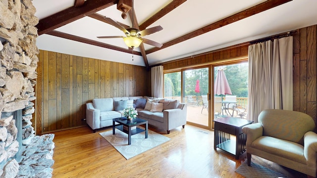 209 Viola Ln, Prospect Heights, IL 60070 - living area with wood walls, beam ceiling, ceiling fan, light wood-style floors, and a stone fireplace