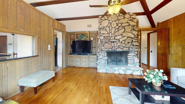 209 Viola Ln, Prospect Heights, IL 60070 - living room featuring beamed ceiling, wooden walls, ceiling fan, wood finished floors, and a fireplace