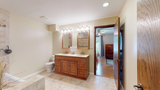 209 Viola Ln, Prospect Heights, IL 60070 - bathroom with double vanity, toilet, baseboards, and ceiling fan
