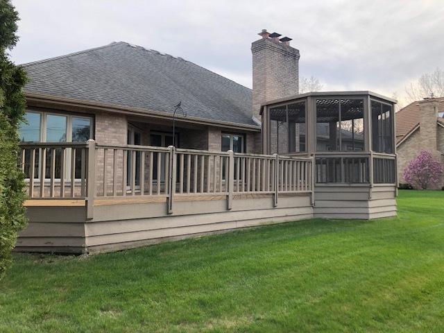 1144 W Trinity Dr, Addison, IL 60101 - back of house with a chimney, a lawn, a shingled roof, and a sunroom