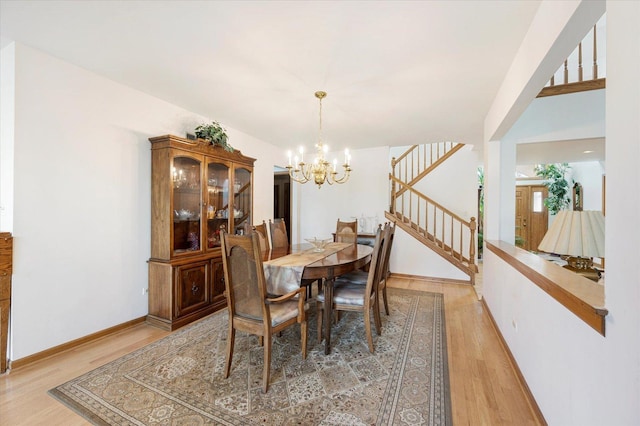 1144 W Trinity Dr, Addison, IL 60101 - dining room with a chandelier, light wood-style flooring, stairs, and baseboards